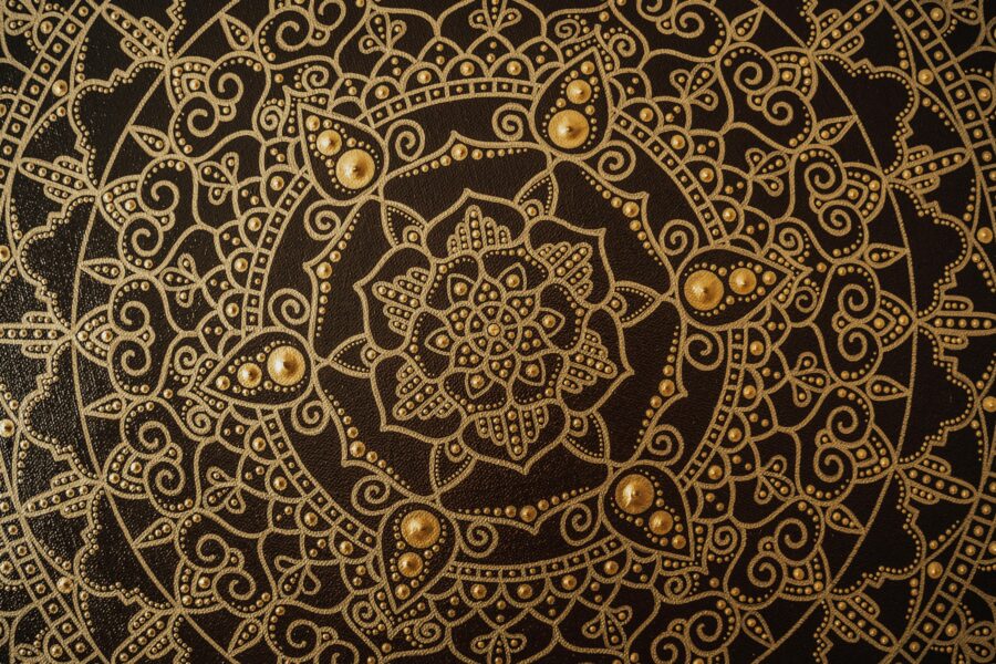 A gold and black, intricate mandala pattern.