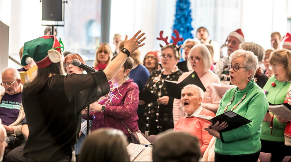 A group of people singing in a choir.