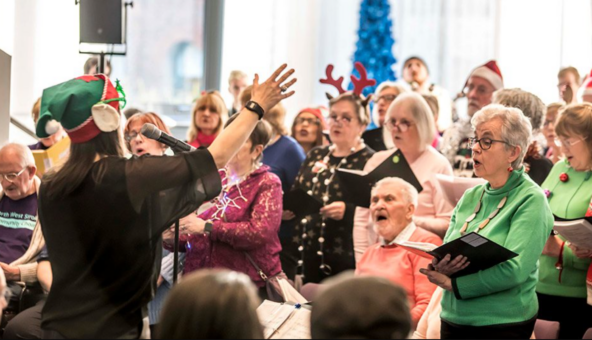 A group of people singing in a choir.