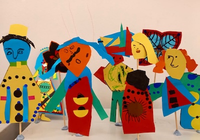 Paper models of people dressed in brightly coloured clothes