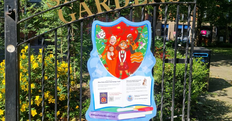 The park gates of Sackville Gardens with a Blue Peter poster displayed on them.