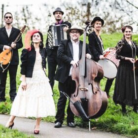 The band She'Koyokh with their instruments in a park