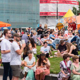 A crowd of people sitting at the Festival Piazza