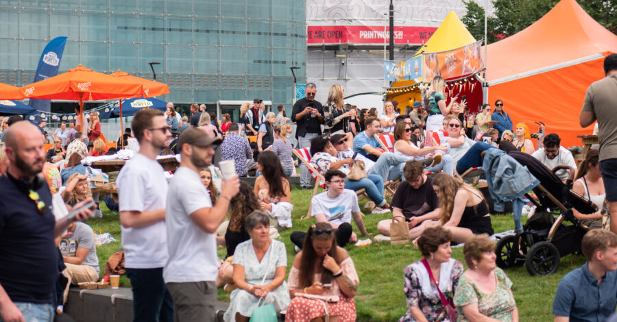 A crowd of people sitting at the Festival Piazza