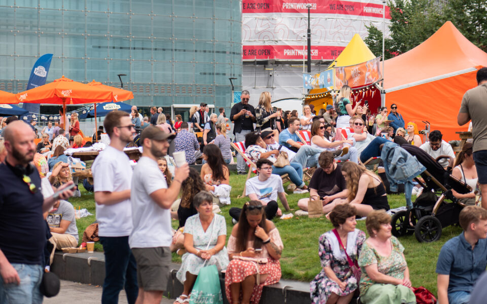 A crowd of people sitting at the Festival Piazza
