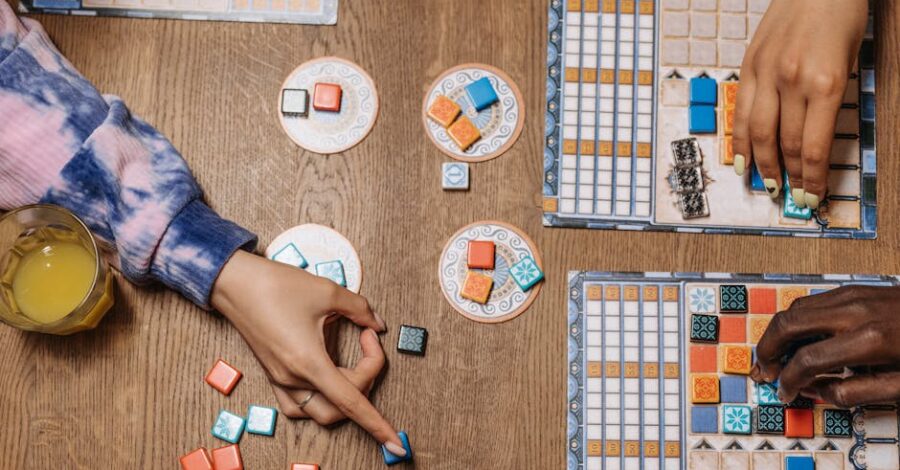 Two people playing a board game with orange and blue counters.