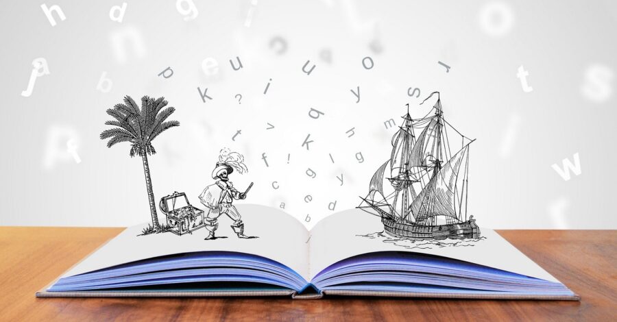 A storybook lies open on a table. The letters and illustrations appear to come to life above the pages.