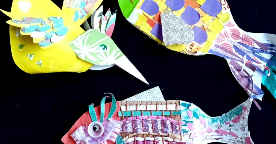 Two multi-coloured fish and a bird which have been made using a variety of crafting materials, such as paper and fabric.