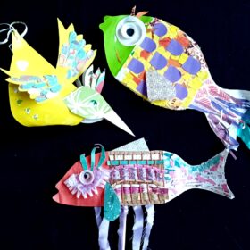 Models of two multi-coloured fish and a bird which have been made using a variety of crafting materials, such as paper and fabric.