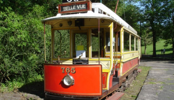 One of Heaton Parks heritage trams. It is painted red , white and yellow and has the number '53' and the words 'Belle Vue' on the front.