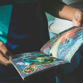 A child holding a comic book open