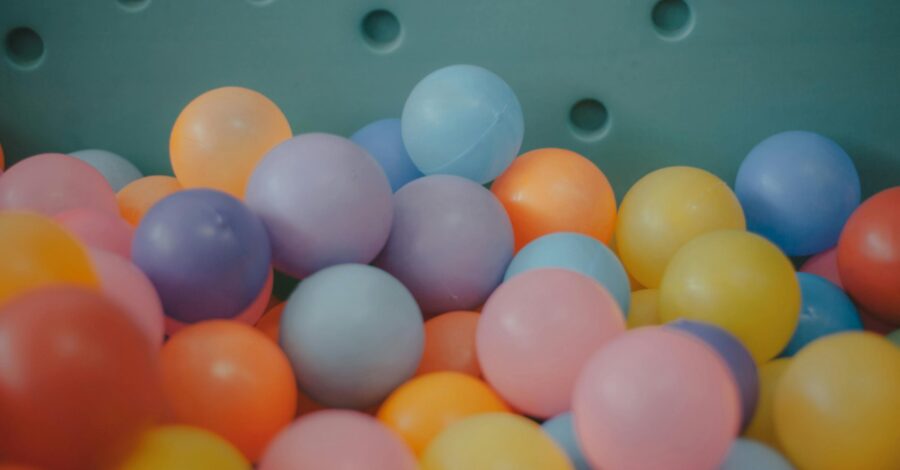 A number of small plastic balls in pastel colours like blue, pink, lilac, yellow and orange.