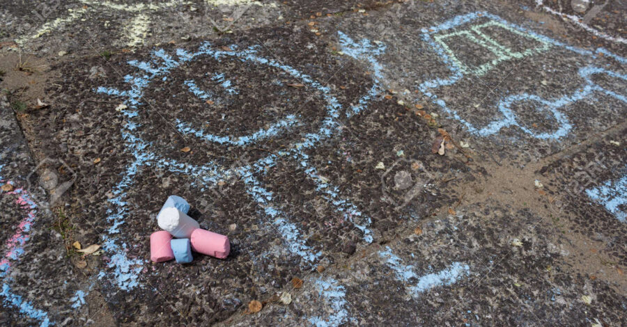 Drawings on the floor made with blue chalk. There are some pieces of pink, blue and white chalk there too.