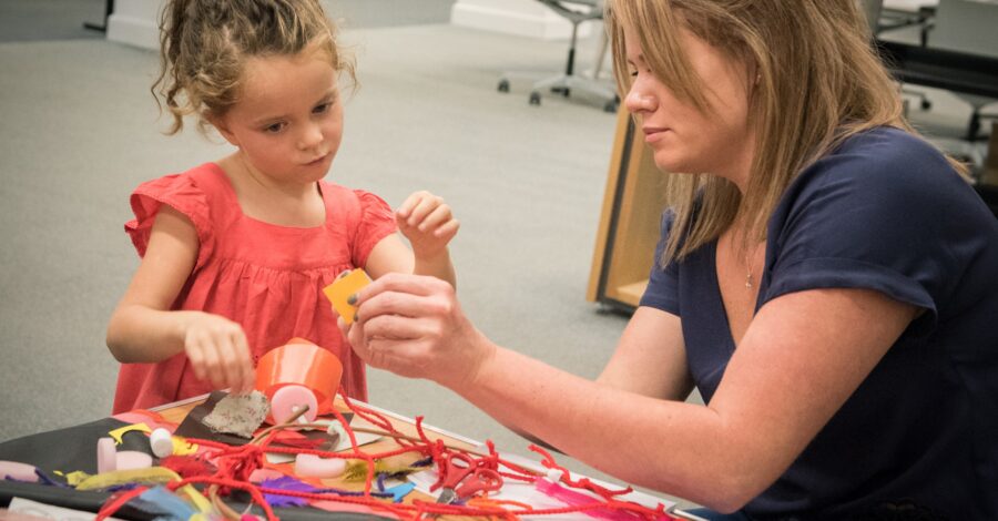 Woman making dream catchers with a young girl