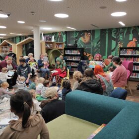 Children and adults attending BSL Storytime event at Manchester Central Library