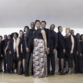 The people of AMC Gospel Choir standing next to oneanother in a v shape.