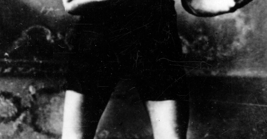 Black and white photo of Len Johnson in boxing attire and in a fighting stance.