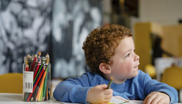 A young boy enjoying a colouring activity.