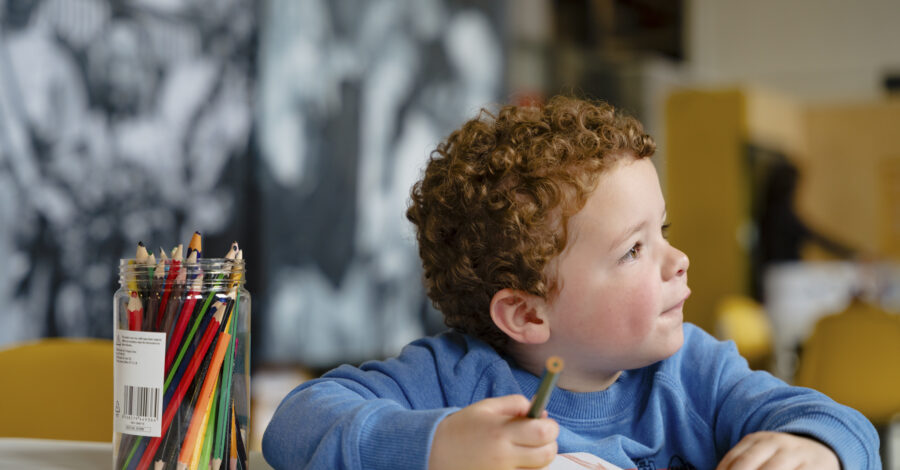 A young boy enjoying a colouring activity.