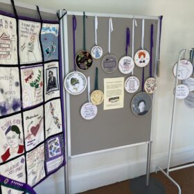 A display of textile art, including a banner, at Elizabeth Gaskell's House.