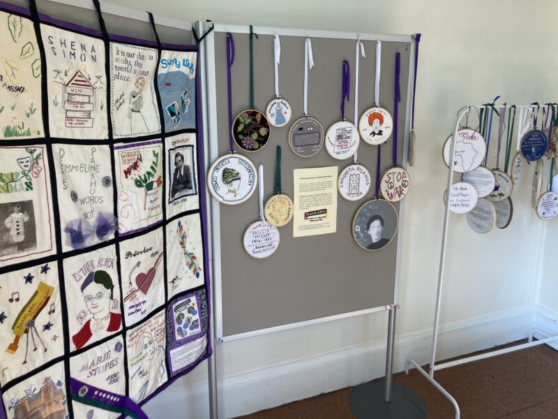 A display of textile art, including a banner, at Elizabeth Gaskell's House.