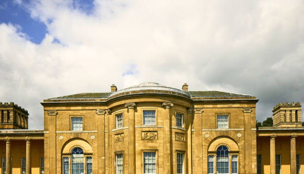 The front of Heaton Hall on a bright day. There is a big white cloud in the sky.