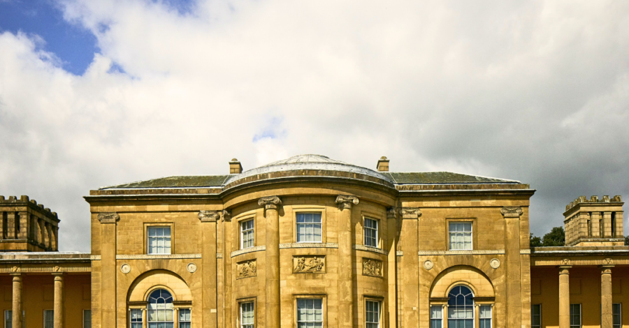 The front of Heaton Hall on a bright day. There is a big white cloud in the sky.