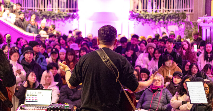 A musician performs to a packed Main Hall at Manchester Museum, during one of their Museum Lates.