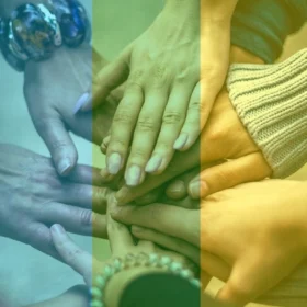 A number of different people's hands placed on top of eachother.