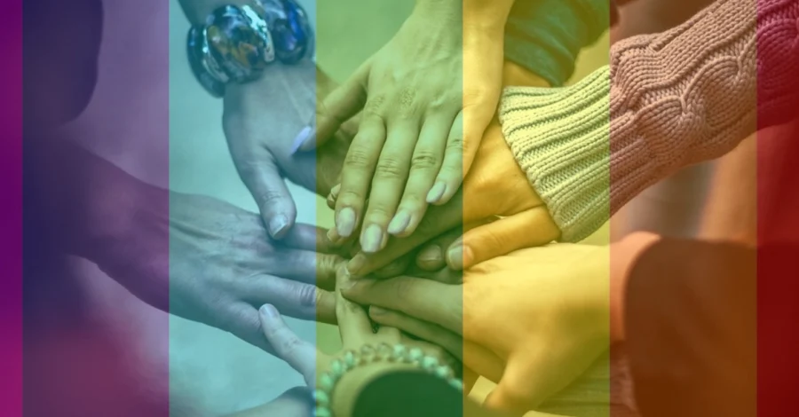 A number of different people's hands placed on top of eachother.