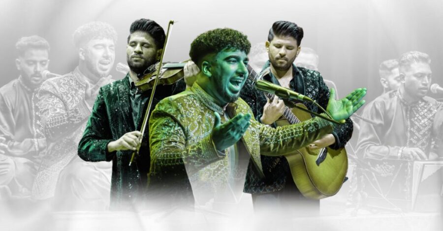 A male Qawwali singer in green jacket in front of 2 musicians playing violin and guitar