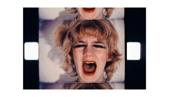 A film still, showing a woman's face screaming.