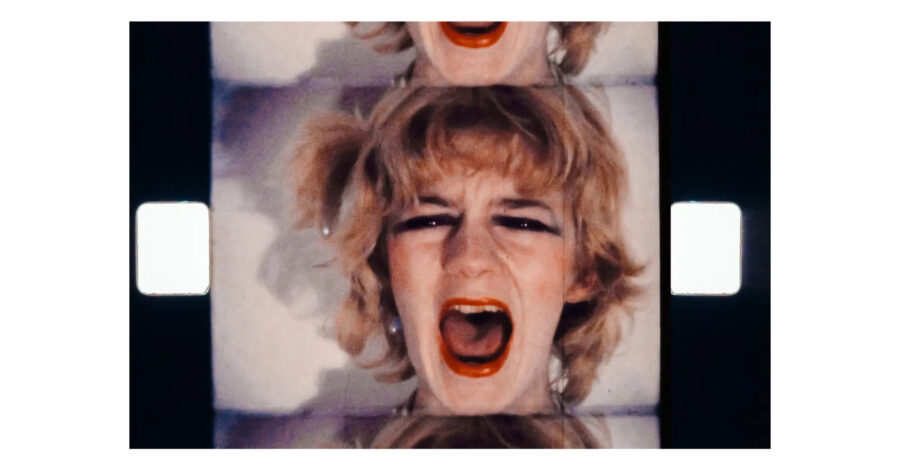 A film still, showing a woman's face screaming.