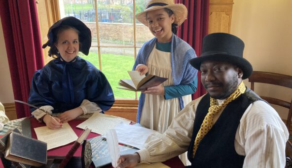A family dressed in traditional Victorian costume.
