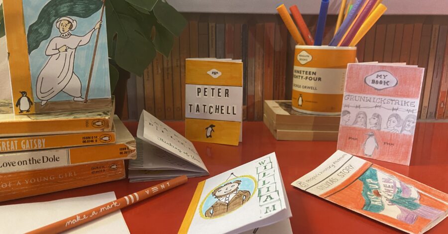 A display of mini paperback books and pencils.