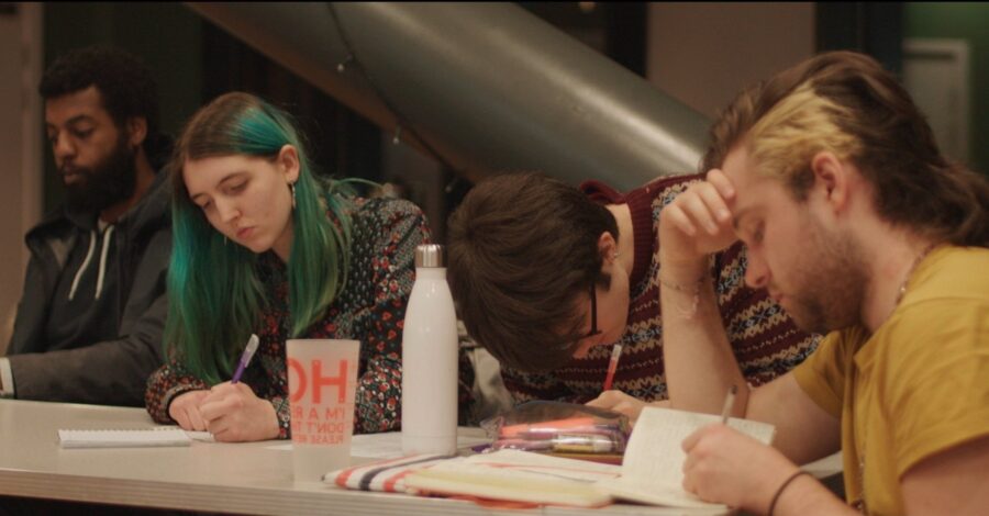 A group of young people engage in creative writing.