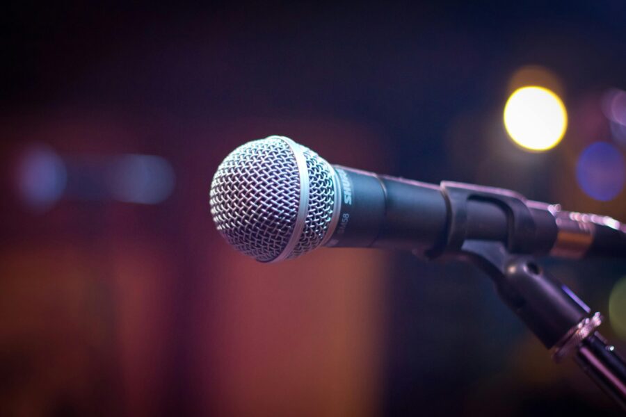 A silver and black microphone on a stand.