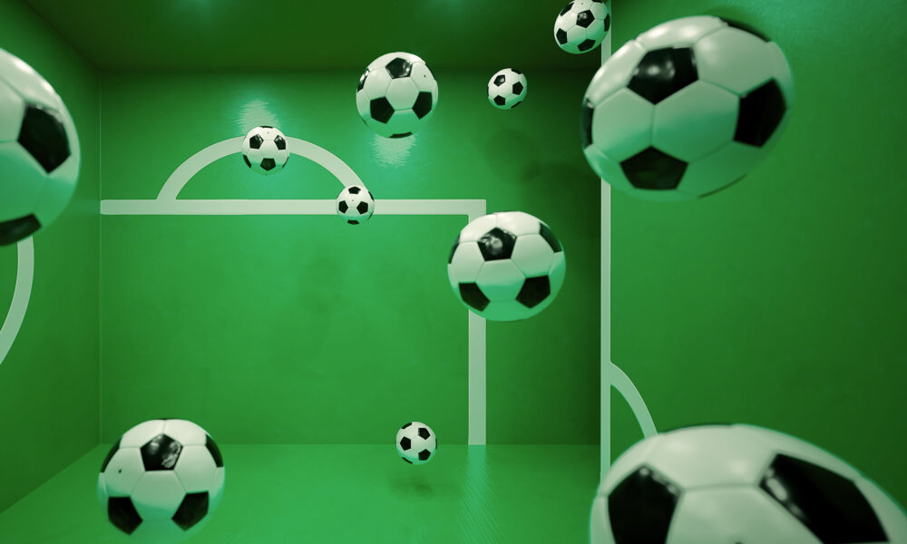 Multiple floating footballs inside a green room with white goalpost markings on the walls. The perspective and reflections create an illusion of depth, making it appear as if the balls are suspended in mid-air.