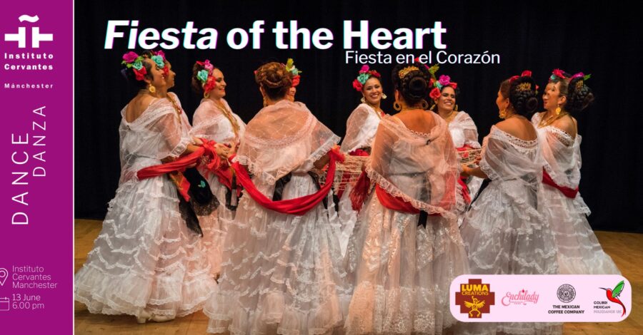 A group of female Mexican dancers in traditional dress of long full-skirted white dresses made of lace, red scarfs and flowers in their hair.