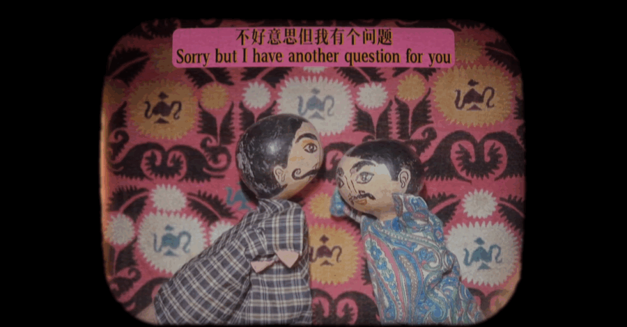 Two colorful hand puppets. One wears a plaid shirt, while the other is dressed in a vibrant, paisley-patterned outfit.