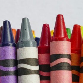 A line of different coloured crayons.