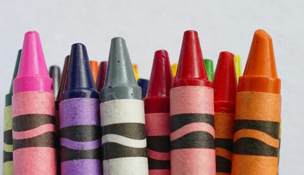 A line of different coloured crayons.