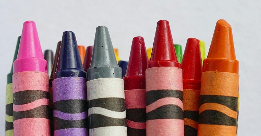 A line of different coloured crayons.