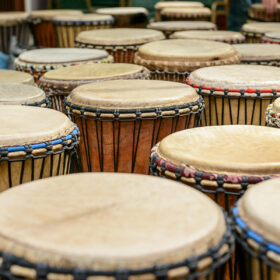 A number of drums laid out in rows.