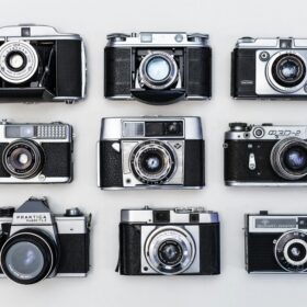 Black and white image of 9 film cameras
