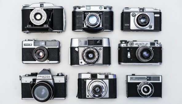 Black and white image of 9 film cameras