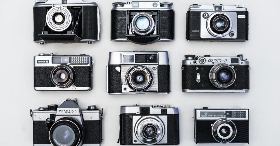 Black and white image of 9 film cameras