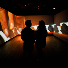 People watch a film within the performance space in Manchester Museum's South Asia Gallery.