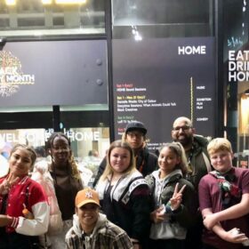 A grioup of young people stood outside HOME Manchester.