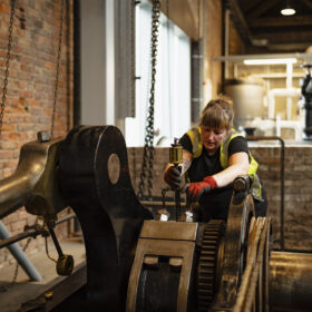 Museum technician with engine in Power Hall